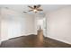 This bedroom features a ceiling fan, a closet, hardwood floors, and easy access to the staircase at 2411 Sabastian St, Mount Dora, FL 32757