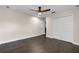 This bedroom features hardwood floors, a ceiling fan, and a closet space for easy organization at 2411 Sabastian St, Mount Dora, FL 32757