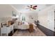 Cozy bedroom with ceiling fan, a comfortable bed, and stylish decor at 2411 Sabastian St, Mount Dora, FL 32757