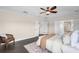 Inviting bedroom with ceiling fan, a comfortable bed, and private bath access at 2411 Sabastian St, Mount Dora, FL 32757