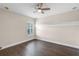 The room includes a ceiling fan, decorative crown molding, a bright window, and hardwood floors at 2411 Sabastian St, Mount Dora, FL 32757