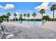 Inviting community pool area with lounge chairs and palm trees, providing a perfect spot for relaxation at 2411 Sabastian St, Mount Dora, FL 32757