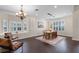 Bright dining room featuring hardwood floors, neutral paint, plantation shutters, and modern chandelier at 2411 Sabastian St, Mount Dora, FL 32757