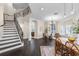 Bright dining room featuring hardwood floors, neutral paint, plantation shutters, and iron stair railing at 2411 Sabastian St, Mount Dora, FL 32757