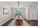 Bright dining room featuring hardwood floors, neutral paint, plantation shutters, and modern chandelier at 2411 Sabastian St, Mount Dora, FL 32757