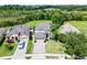 Charming single-Gathering home features a manicured lawn, brick driveway, and attached two-car garage at 2411 Sabastian St, Mount Dora, FL 32757