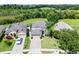 Well-maintained single-Gathering home with two-car garage, brick driveway, and verdant front lawn at 2411 Sabastian St, Mount Dora, FL 32757