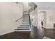 Bright foyer featuring hardwood floors, neutral paint, and iron stair railing at 2411 Sabastian St, Mount Dora, FL 32757