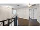 Hallway boasts hardwood floors, decorative railing and elegant lighting fixtures at 2411 Sabastian St, Mount Dora, FL 32757