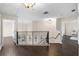 Spacious hallway featuring hardwood floors, elegant lighting, and decorative railing at 2411 Sabastian St, Mount Dora, FL 32757