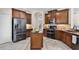 The kitchen features wooden cabinetry, stainless steel appliances, and a center island at 2411 Sabastian St, Mount Dora, FL 32757