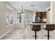 Bright kitchen with a bay window seating area, wooden cabinets, and counter seating at 2411 Sabastian St, Mount Dora, FL 32757