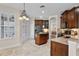 Spacious kitchen with wooden cabinets, granite countertops, and stainless steel appliances at 2411 Sabastian St, Mount Dora, FL 32757