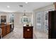 Well-lit kitchen with a center island, bay window, and stainless steel refrigerator at 2411 Sabastian St, Mount Dora, FL 32757