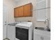 A conveniently located laundry room featuring matching washer and dryer, a utility sink, and storage at 2411 Sabastian St, Mount Dora, FL 32757