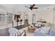 Open-plan living room with hardwood floors, neutral paint, ceiling fan, and bar seating at 2411 Sabastian St, Mount Dora, FL 32757