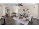 Bright living room featuring hardwood floors, neutral paint, ceiling fan, and stylish decor at 2411 Sabastian St, Mount Dora, FL 32757