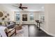 Bright living room featuring hardwood floors, neutral paint, ceiling fan, and bar seating at 2411 Sabastian St, Mount Dora, FL 32757