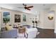 Comfortable living room with hardwood floors, neutral paint, ceiling fan, and lots of light at 2411 Sabastian St, Mount Dora, FL 32757