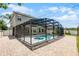 A beautiful screened-in pool and spa area, complemented by a paved patio and backyard views for outdoor living at 2411 Sabastian St, Mount Dora, FL 32757