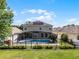 A stunning screened pool with an attached spa, surrounded by a bright concrete patio, and featuring string lights at 2411 Sabastian St, Mount Dora, FL 32757