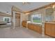 Large bathroom with tile flooring, dual vanities, and a garden view, creating a relaxing environment at 25057 Riverwalk Dr, Leesburg, FL 34748