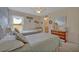 A light filled bedroom with two twin beds, neutral decor, and a view to the outdoors at 25057 Riverwalk Dr, Leesburg, FL 34748