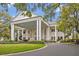 Grand clubhouse featuring a circular driveway, towering columns, and manicured landscaping at 25057 Riverwalk Dr, Leesburg, FL 34748