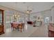 Bright and airy dining room featuring a large window and an elegant chandelier at 25057 Riverwalk Dr, Leesburg, FL 34748
