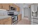 A kitchen with stainless steel appliances and light wood cabinets at 25057 Riverwalk Dr, Leesburg, FL 34748
