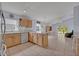Open kitchen with a view of the living area and sliding glass doors to the outdoors at 25057 Riverwalk Dr, Leesburg, FL 34748