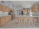 Open kitchen with stainless steel appliances, light wood cabinets, and center island at 25057 Riverwalk Dr, Leesburg, FL 34748