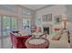 Cozy living room features shuttered French doors, fireplace, and comfortable seating at 25057 Riverwalk Dr, Leesburg, FL 34748