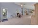 A sunny living area with tile flooring and access to the outdoor patio through a glass door at 25057 Riverwalk Dr, Leesburg, FL 34748