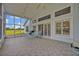 Tiled screened-in patio with serene backyard views, perfect for outdoor living and entertaining at 25057 Riverwalk Dr, Leesburg, FL 34748