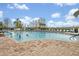 Inviting swimming pool with lounge chairs, set against a blue sky with trees, perfect for relaxation and recreation at 25057 Riverwalk Dr, Leesburg, FL 34748