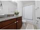 Bathroom showcasing a granite vanity, shower/tub, and neutral-toned tiling at 2790 Monticello Way, Kissimmee, FL 34741