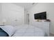 Bright bedroom with light grey bedspread, white dresser, and ample closet space at 2790 Monticello Way, Kissimmee, FL 34741