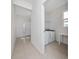 Inviting foyer featuring tile flooring, decorative glass door accents, and laundry area access at 2790 Monticello Way, Kissimmee, FL 34741