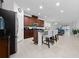 Open kitchen with a large island, granite counters, stainless appliances, and seamless flow to the living area at 2790 Monticello Way, Kissimmee, FL 34741