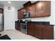 Kitchen showcases dark wood cabinets, granite countertops, and stainless steel appliances at 2790 Monticello Way, Kissimmee, FL 34741