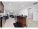 Open-concept kitchen with island, stainless steel appliances, granite countertops and a view of the living area at 2790 Monticello Way, Kissimmee, FL 34741