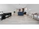 Expansive living room seamlessly connects to the kitchen and features light hardwood style flooring at 2790 Monticello Way, Kissimmee, FL 34741