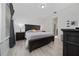 Spacious main bedroom with wood floors, complemented by modern lamps and decor at 2790 Monticello Way, Kissimmee, FL 34741