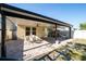 A covered outdoor patio features a dining table set, fans, a playhouse, and hammock at 2790 Monticello Way, Kissimmee, FL 34741