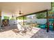A covered patio includes a dining table set, playhouse, hammock, and slide at 2790 Monticello Way, Kissimmee, FL 34741