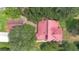 Aerial view of a red roof home surrounded by lush greenery, offering privacy and charm at 3085 Vest Rd, St Cloud, FL 34772