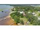 An aerial view of a lakefront property with a sandy beach, boat docks, and lush greenery at 3085 Vest Rd, St Cloud, FL 34772