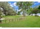 Expansive backyard with lush green grass, mature trees, and a fenced area ideal for outdoor activities and pets at 3085 Vest Rd, St Cloud, FL 34772