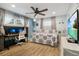 Cozy bedroom features a ceiling fan, work space and decor, with an inviting atmosphere at 3085 Vest Rd, St Cloud, FL 34772
